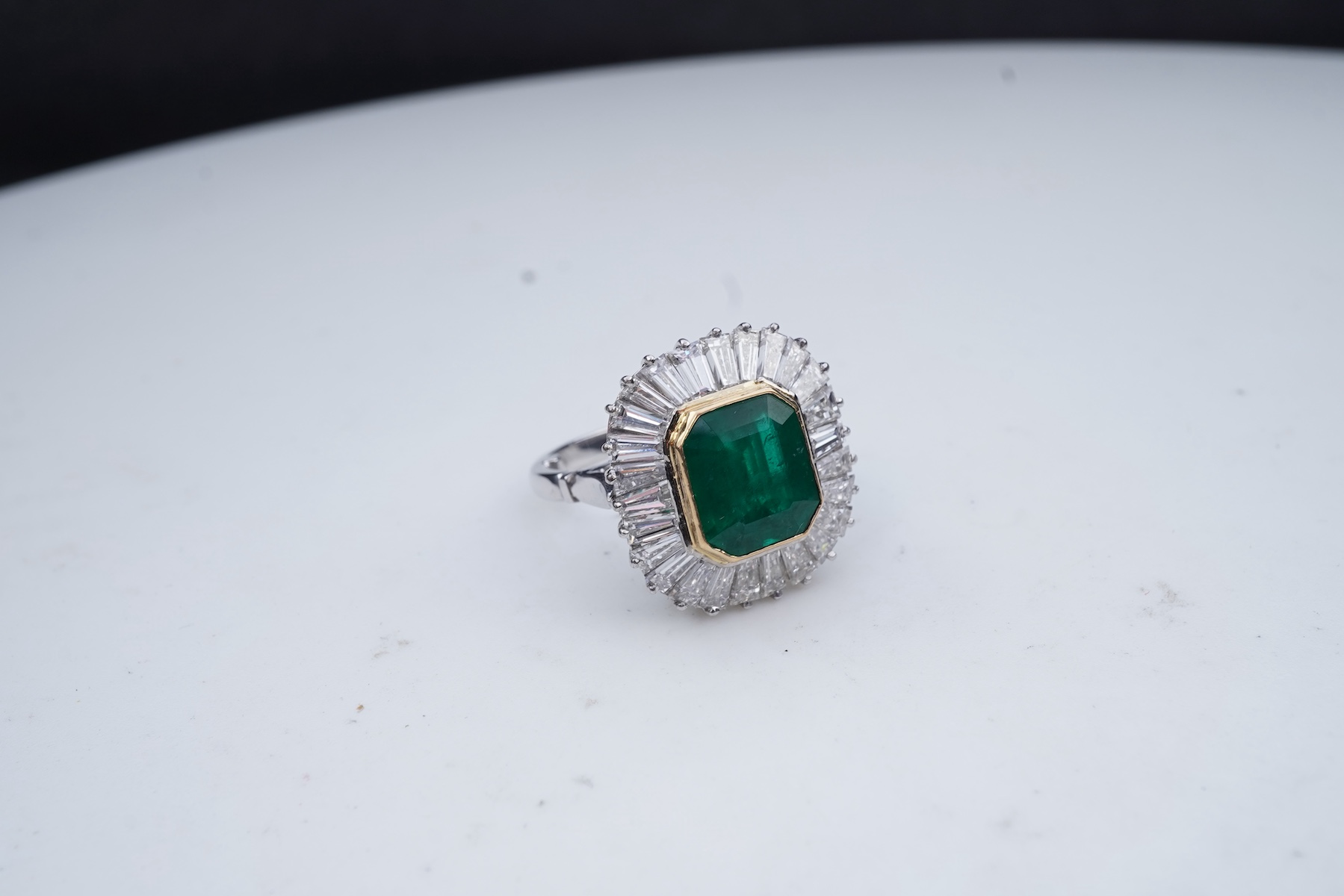 An emerald and diamond ring